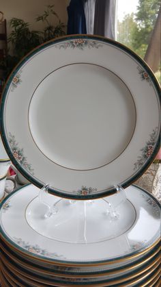 a stack of white and gold plates stacked on top of each other