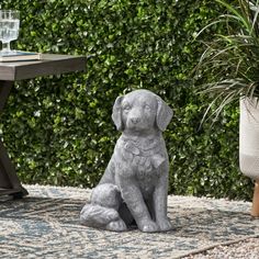 a statue of a dog sitting on top of a rug next to a table and chair