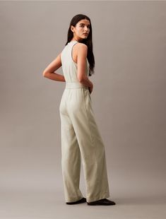 Made from a smooth viscose blend, this jumpsuit has a refined, streamlined shape. Created with sleeveless styling, straight legs, and a self-tie belt at the waist. Detailed with an invisible zipper at the back.  Material: 76% Viscose, 24% Polyester. Sleeveless Jumpsuits And Rompers With Tie Fastening For Spring, Chic Sleeveless Jumpsuits And Rompers With Tie Waist, Chic Belted Strapless Jumpsuit For Work, Sleeveless Belted Jumpsuits And Rompers, Casual Sleeveless Belted Jumpsuits And Rompers, Belted Strapless Jumpsuit For Workwear, Belted Strapless Sleeveless Jumpsuit, Belted Strapless Jumpsuit, Sleeveless Belted Jumpsuit For Work