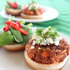 some food is sitting on top of a white plate with green leaves and red peppers