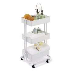 a white cart with three shelves and two bottles on it's wheels is shown