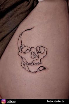 a woman's stomach with a skull tattoo on the side of her belly, which is drawn in black ink