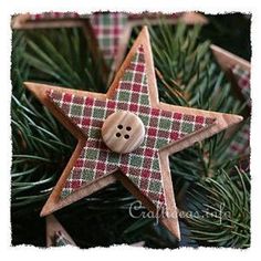 a wooden star ornament with a button on it sitting on a christmas tree