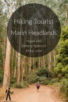 a person walking down a dirt road in the woods with text overlay reading hiking tourist main headlands hawk hill battery spencer kibby cove