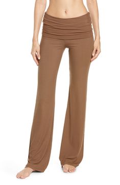 These soft, stretchy ribbed pants with a foldover waistband and flared legs are from Kim Kardashian West's sought-after SKIMS. 32" inseam; 21" leg opening; 11" front rise; 15" back rise (size Medium) 91% modal, 9% spandex Machine wash, dry flat Imported Stretch Brown Wide Leg Pants For Loungewear, Fall Flare Yoga Pants, Flare Leggings With 4-way Stretch, Solid Flare Yoga Pants For Loungewear, Flared Leggings With 4-way Stretch, Fitted Wide Leg Yoga Flares, Flare Yoga Bottoms, Fitted Wide Leg Yoga Pants For Loungewear, Stretch Flare Wide Leg Pants