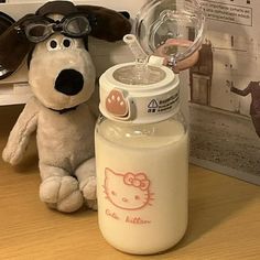 a stuffed dog is next to a baby bottle