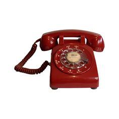 an old fashioned red telephone on a white background