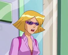 a woman with blonde hair and sunglasses standing in front of a door wearing purple glasses