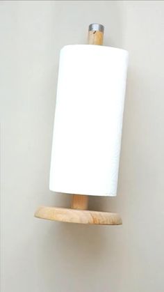 a cloud lamp is sitting on top of a stool in front of a brick wall