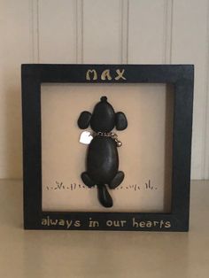 a black bear is in a frame with the words max and always in our hearts