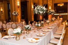 a table set up with white flowers and place settings for an elegant wedding reception at the fairmont hotel