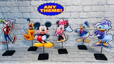 mickey mouse and other cartoon characters on display in front of a brick wall with any theme