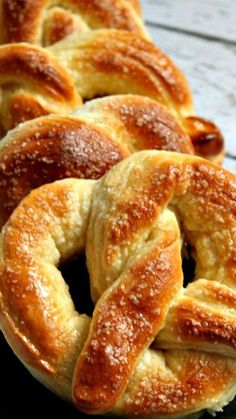 several braided breads sitting on a black plate