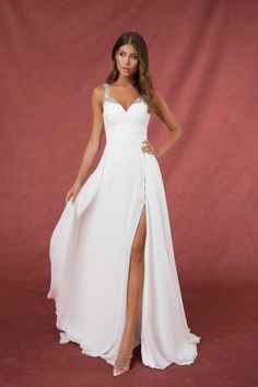 a woman wearing a white dress with a slit in the side and one leg up