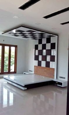 an empty room with black and white tiles on the walls, flooring and ceiling