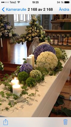 a table with flowers and candles on it