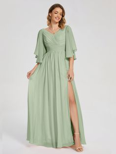 a woman wearing a long green dress with a slit down the side and one leg