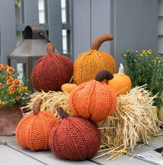 knitted pumpkins and hay bales on the porch