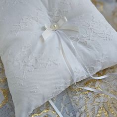 a white pillow with a bow on it