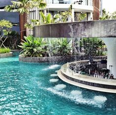 an outdoor fountain in the middle of a swimming pool