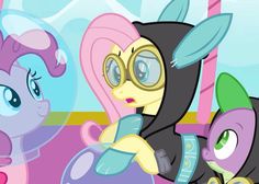 the three ponies are wearing goggles and looking at something in front of them