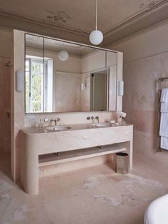 a bathroom with two sinks and a large mirror