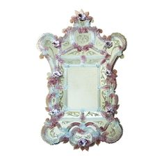 an ornate mirror with pink and white flowers on the edges is shown against a white background