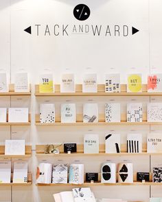 a store display with lots of greeting cards on the shelves and in front of it is a sign that says tack and ward