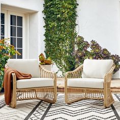 two wicker chairs sitting next to each other on top of a rug