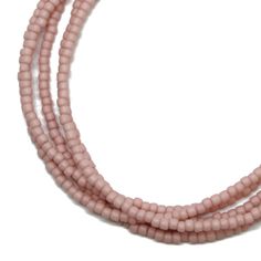 "A soft pastel pink single strand seed bead necklace.  The beads have a soft matte finish.  It could be layered with others or worn alone. Delicate and very feminine. The necklace will be made to order and is available in many different lengths, from short choker to extra-long. I hand string these seed beads on beading wire and finish them with a sterling silver lobster clasp and ring. This is a single strand necklace, but the longer lengths can be wrapped. Pastel Pink Glass Beads 1.5mmx 2.2mm S Pink Beaded Necklace, Neck Choker, Pink Necklace, Jewelry Studio, Beading Wire, Seed Bead Necklace, Amazon Handmade, Plastic Beads, Beaded Choker