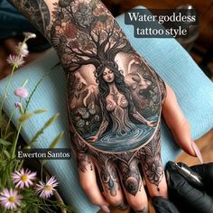 a woman's hand with tattoos on it and the words water goddess tattoo style