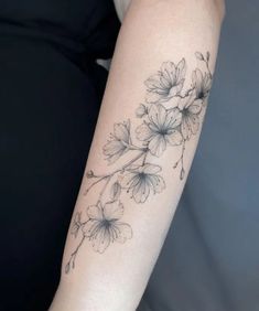 a woman's arm with flowers on it