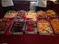 many trays of food on a red table