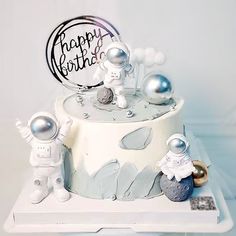 a birthday cake with an astronaut on top