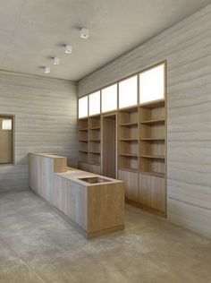 an empty room with bookshelves and cabinets in it