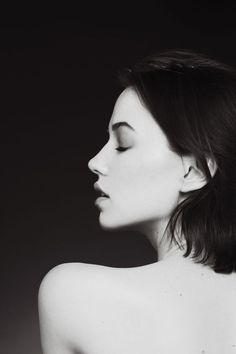 a black and white photo of a woman's back with her hands on her hips