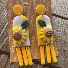 the earrings are made out of plastic and have sunflowers on them