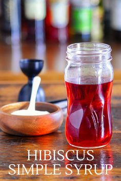 Red Hibiscus syrup in a glass jar with red Hibiscus flower and wooden bowl of sugar Simple Syrup Infusions, Hibiscus Simple Syrup Recipe, Hibiscus Flower Drink Recipes, Hibiscus Simple Syrup, Hibiscus Syrup Cocktail, Hibiscus Liqueur, Hibiscus Recipe, Hibiscus Syrup