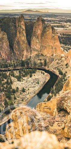 a river running through a valley surrounded by mountains