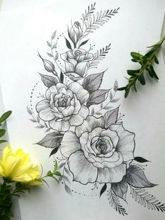 a drawing of flowers on paper next to some green leaves and yellow flower buds in the background