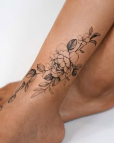 a woman's leg with a flower tattoo on it