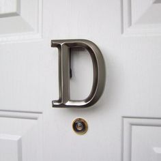 the letter d is attached to a door handle