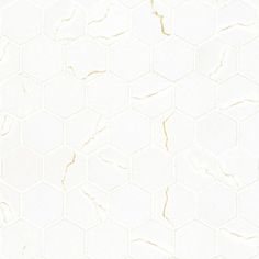 a white tile wall with hexagonal tiles in the middle and gold lines on it