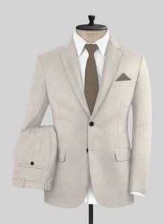 Sometimes a look speaks volumes, while at other times, let your outfit do the talking! Our Napolean Ricci Muted Beige Wool Suit is sure to make a statement. Crafted with a refined wool blend, this beige suit's tailored fit and solid pattern give it timeless appeal. The luxuriously composed wool-rich cloth ensures comfort and flexibility, whether you're tackling a busy day at the office or attending daytime events that extend into the evening.  Look Includes    Napolean Ricci Muted Beige Wool  Fabric  Two Button Jacket Style  Notch Lapel  Horn Brown Buttons  Single Vent  Three Cuff Buttons  Two Welted Back Pockets on Trousers   Click 'Customize Now' to modify the look if needed.  Lining: Viscose, Dry Clean, Pants can be lightly washed. Luxury Wool Suit With Pressed Crease, Luxury Wool Three-piece Suit For Business Meetings, Luxury Classic Three-piece Suit With Button Closure, Luxury Classic Unstitched Suit, Luxury Wool Suits With Pressed Crease, Beige Suits, Italian Suit, Linen Suits, Tweed Suits