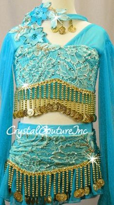 Turquoise custom made 2 piece long sleeve top and asymmetrical skirt. Base of the costume is Turquoise lycra top and trunk with Lt Teal Blue floral lace, Teal Blue sheer mesh sleeves, neckline and skirt. Accented with Lt Teal Blue embroidered flower appliques, Gold dangling beaded/coin trim and Swarovski rhinestones! **Accessories Include: Headpiece Almost 6 gross Blue Zircon Shimmer 30ss, Blue Zircon Shimmer 20ss, Blue Zircon Shimmer 16ss, Blue Zircon Shimmer 1ss, Lt Turquoise AB 30ss, Lt Turquoise AB 20ss, Lt Turquoise AB 16ss, Lt Turquoise AB 12ss, Lt Colorado Topaz 30ss, Lt Colorado Topaz 20ss, and Lt Colorado Topaz 16ss rhinestones!! Long Sleeve Top And Skirt, Baggy Clothing, Trio Costumes, Sequin Jewelry, Costumes Couture, Lace Long Sleeve Top, Sequin Appliques, Tutu Costumes, Blue Sheers