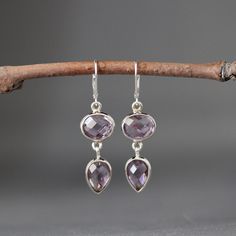 "Stunning faceted natural Purple Amethyst oval and pear shaped stones are bezel set in silver. These dangle from silver lever back earwires. Gorgeous statement earrings in the most neutral color! Amethyst oval bezels: 13x11mm Amethyst pear bezels: 10x13mm Total length of earrings: 1 7/8\" All silver is sterling. As the owner, maker, designer, and curator of this shop, I take great pride in providing you with jewelry that you will love to wear everyday, for special occasions, and for many years t Amethyst Teardrop Crystal Earrings, Faceted Teardrop Earrings For Jewelry Making, February Birthstone Jewelry, Purple And Silver, Earrings Purple, February Birthstone, Amethyst Earrings, Green Gemstones, February Birth Stone