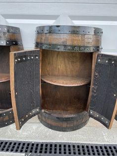 three wooden shelves with metal rivets on the sides and one shelf is open