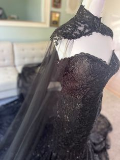 a black dress is on display in a room