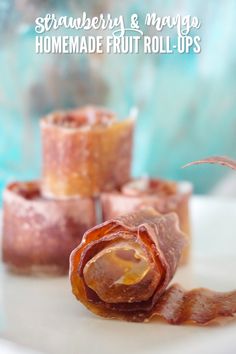 several pieces of bacon sitting on top of a white plate with the words strawberry & mango homemade fruit roll - ups