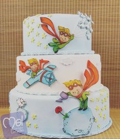 a three tiered cake decorated with cartoon characters